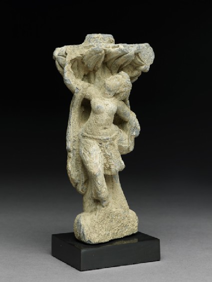 Relief fragment depicting a female dancer beneath a treeside