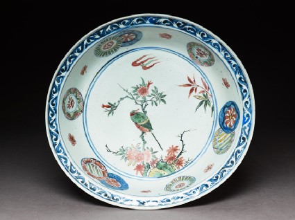 Dish with a bird on a flowering branchtop