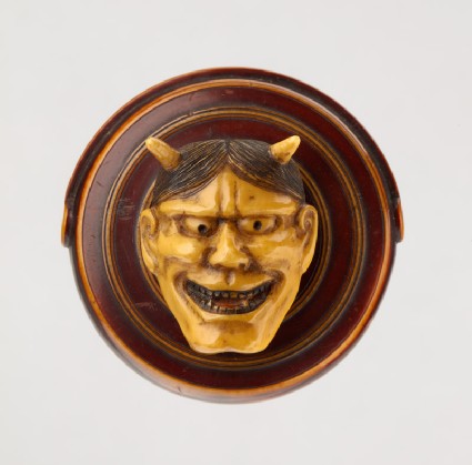 Manjū netsuke in the form of a temple gong and Hannya mask from the Nō play 'Dōjōji'front