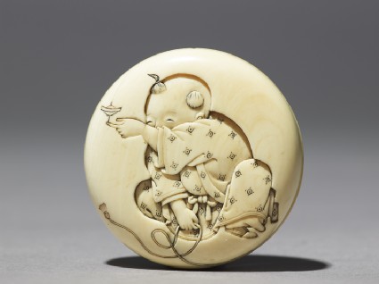 Manjū netsuke with a boy playing with a spinning topfront