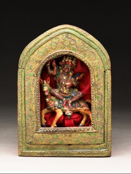 Portable shrine containing a figure of a wrathful female deity on horsebackfront