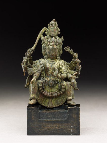 Figure of a multi-headed and multi-armed deityside