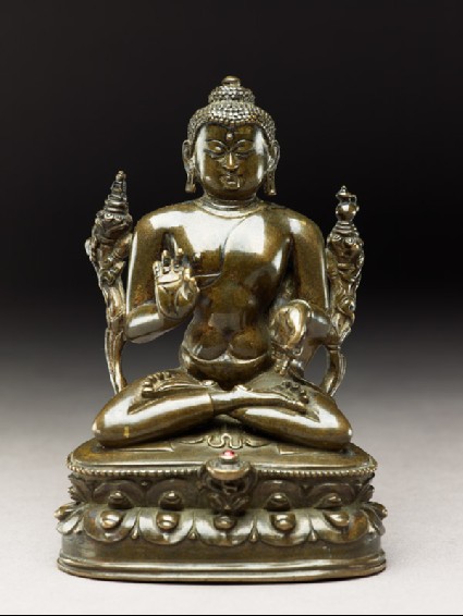 Seated figure of the Buddha with flowers, stupa, and bottlefront