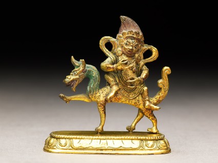 Figure of a male deity seated on a mythical animalside