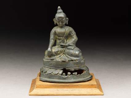 Seated figure of a deity on a lotus-petalled thronefront