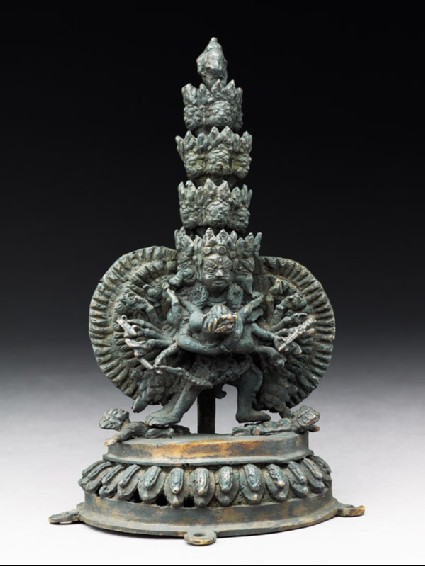 Figure of a multi-headed and multi-armed male deity with his consort, standing on other figuresfront