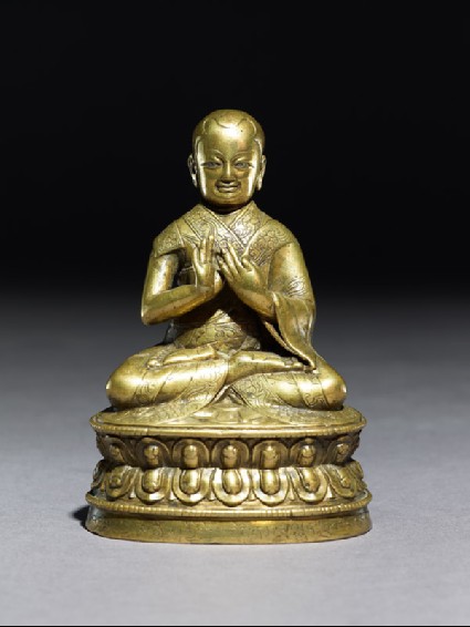 Figure of a seated lamaside