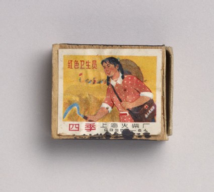 Matchbox depicting a woman holding a sickletop