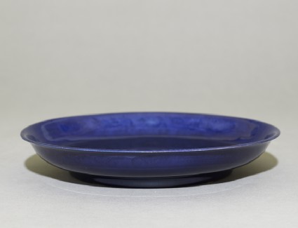 Dish with dragons under a cobalt-blue glazeoblique