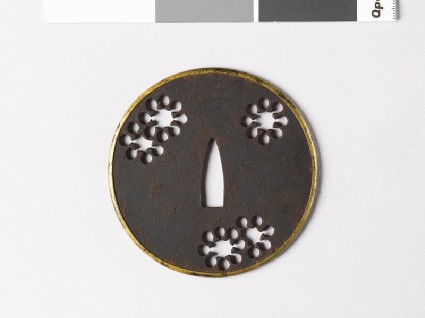 Round tsuba with 'nine-star' mon or snowfront