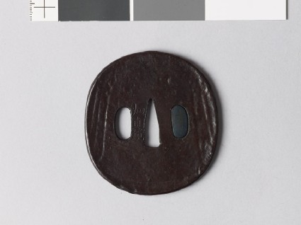 Lenticular tsuba with mitsudomoye, or three-comma shapesfront