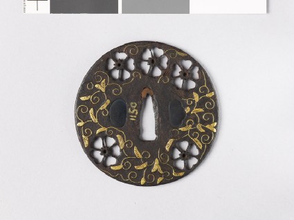 Round tsuba with cherry blossoms and karakusa, or scrolling plant patternfront