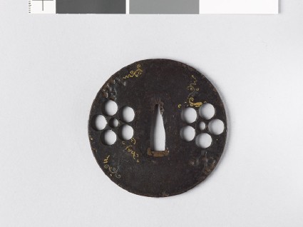 Round tsuba with heraldic mon and scrollsfront