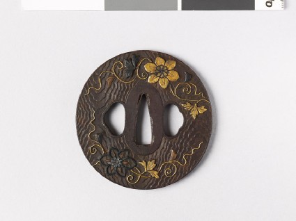 Lenticular tsuba with wood grain decoration and flowersfront