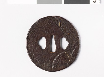 Oval tsuba with banana tree and dewdropsfront