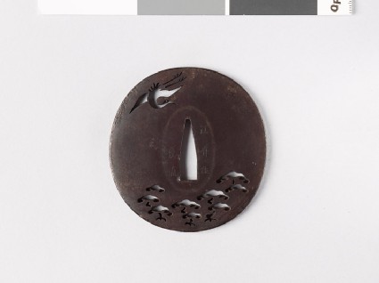 Tsuba with a crane flying above a pine forestfront