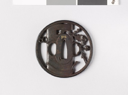 Round tsuba depicting a vase containing flowering plum twigfront