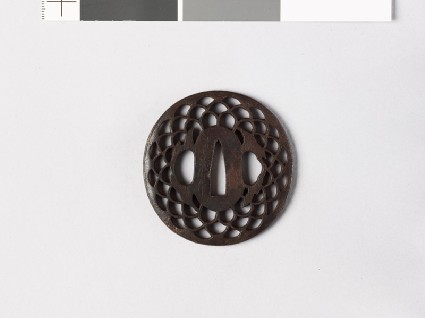 Lenticular tsuba with diaper of overlapping chrysanthemum flowers and leavesfront