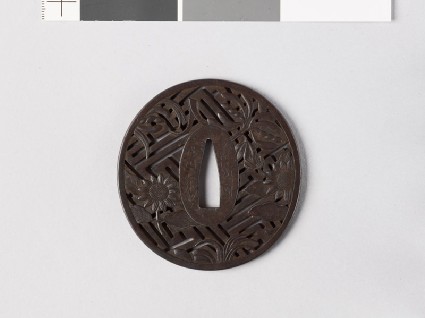 Tsuba with asters, orchids, and rinzu, or swastika-fret diaperfront