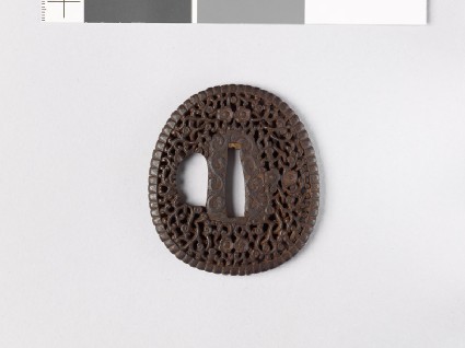 Lenticular, aori-shaped tsuba with floral scrollworkfront