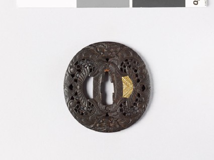 Tsuba with demon mask and scrollworkfront