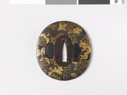 Lenticular tsuba with plants and animalsfront