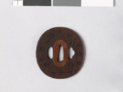 Tsuba with scrolls and mon made from kiri, or paulownia leavesfront