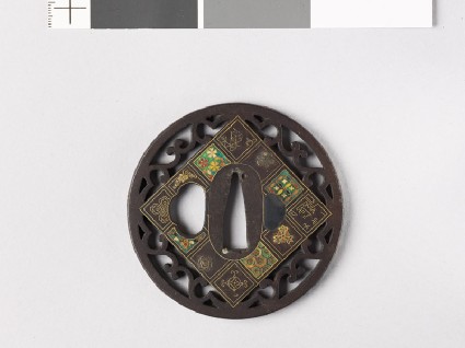Round tsuba with flowers and scrollsfront