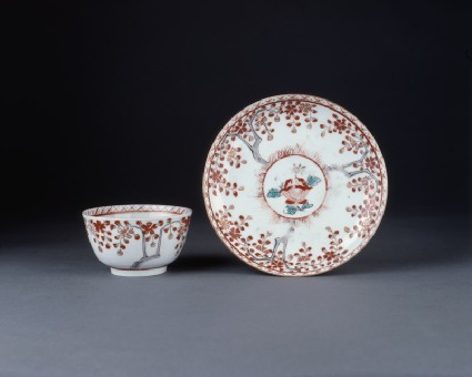 Cup and saucer with flowers and weeping cherry treesoblique