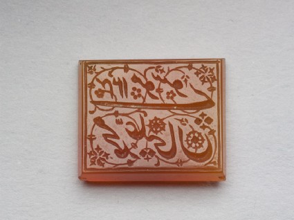Rectangular bezel seal with nasta‘liq inscription, floral, and spiral decorationfront