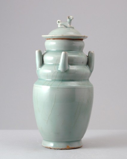 Greenware or qingbai ware funerary vase with lid surmounted by a dogfront