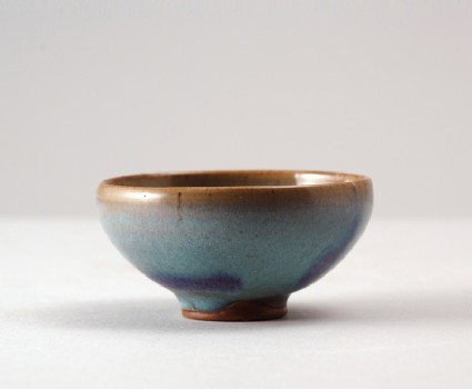 Bowl with blue glaze and purple splashesfront