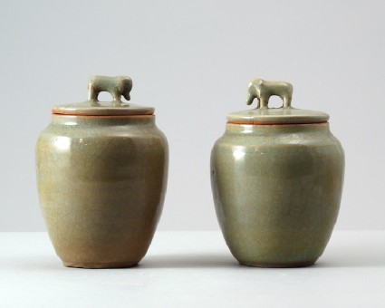 Greenware jar and lid surmounted by an elephantfront