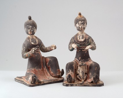 Figure of a seated female attendant with a dogfront