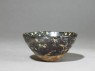 Black ware tea bowl with 'tortoiseshell' glazes (oblique)