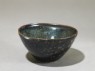 Black ware tea bowl with 'tortoiseshell' glazes (oblique)