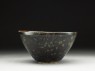 Black ware tea bowl with 'tortoiseshell' glazes (side)