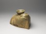 Greenware burial model of stove with food vessels (oblique)