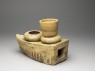 Greenware burial model of stove with cooking vessels (oblique)