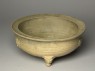 Greenware tripod bowl with hoof-shaped feet (oblique)