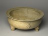 Greenware tripod bowl with hoof-shaped feet (oblique)