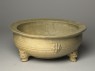 Greenware tripod bowl with hoof-shaped feet (oblique)