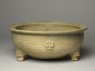 Greenware tripod bowl with hoof-shaped feet (oblique)