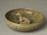 Greenware burial figure of dog in a pen (oblique)