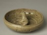 Greenware burial figure of dog in a pen (oblique)