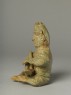 Greenware burial figure of man playing a harp (side)