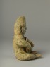 Greenware burial figure of man playing a harp (side)