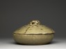 Greenware bowl and lid surmounted by an animal (side)