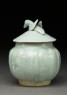 Lidded white ware jar surmounted by bird (side)