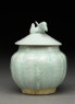 Lidded white ware jar surmounted by bird (side)